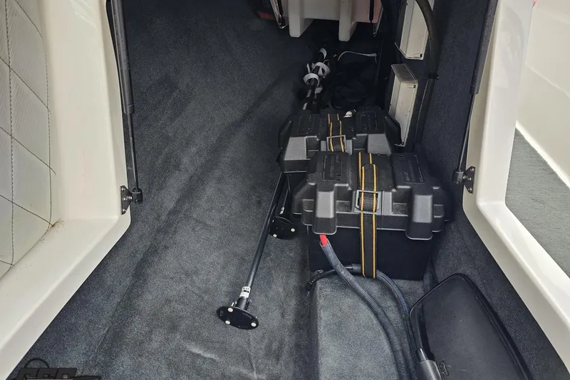 Slide: The Image of Interior of a 2013 MasterCraft X-10 boat showing storage compartment and equipment. - 57