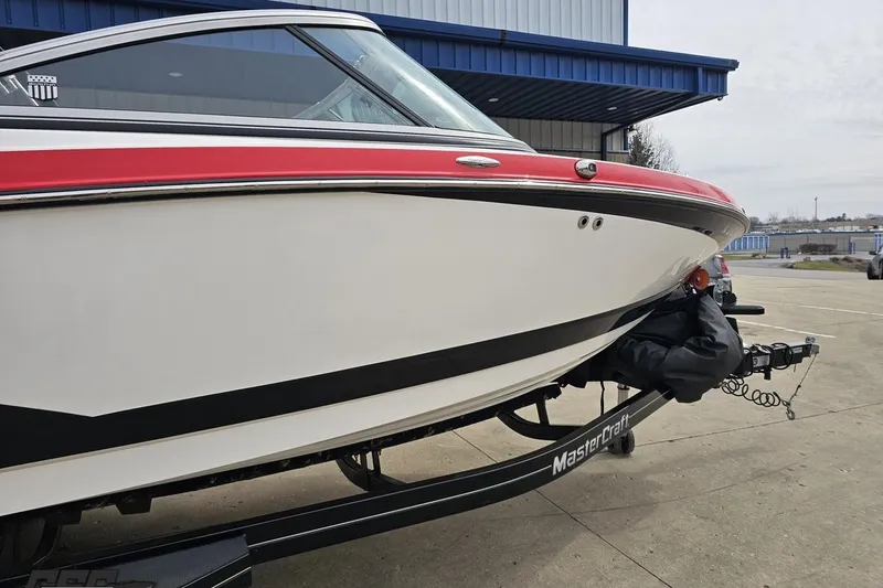 Slide: The Image of 2013 MasterCraft X-10 boat on trailer, featuring sleek design and red accents. - 6