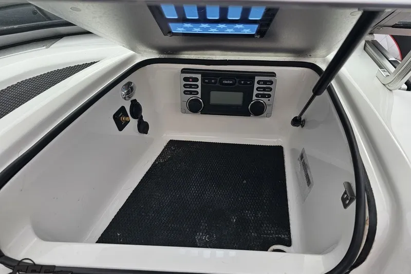 Slide: The Image of 2013 MasterCraft X-10 boat interior with audio system and storage compartment. - 60