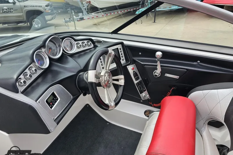 Slide: The Image of Interior of a 2013 MasterCraft X-10 boat featuring a sleek dashboard and steering wheel. - 63