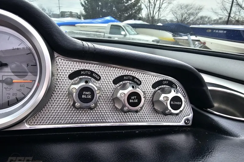 Slide: The Image of Dashboard controls of a 2013 MasterCraft X-10 boat, featuring bilge and blower switches. - 67