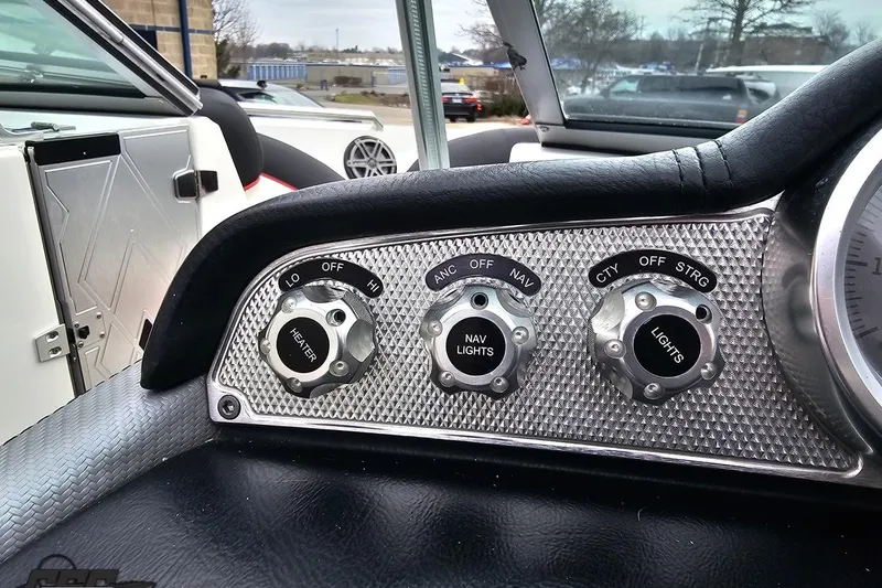 Slide: The Image of Control panel of a 2013 MasterCraft X-10 boat with heater and light switches. - 68