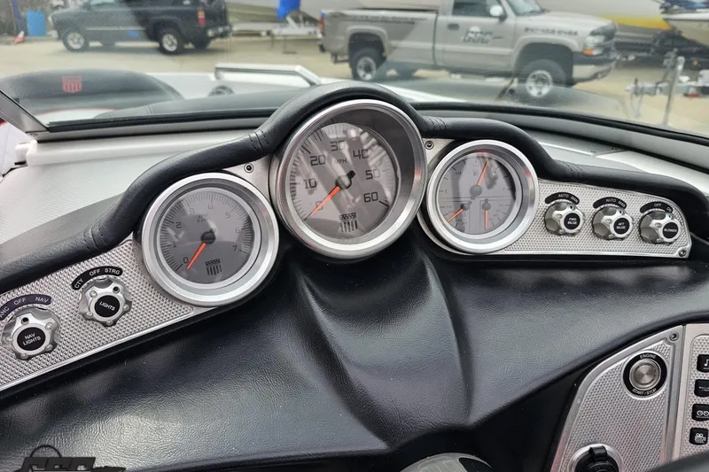 Slide: The Image of Dashboard of a 2013 MasterCraft X-10 boat with gauges and controls. - 69