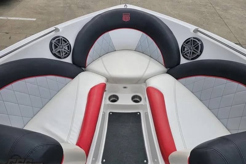 Slide: The Image of 2013 MasterCraft X-10 boat interior with red, black, and white seating and speakers. - 76