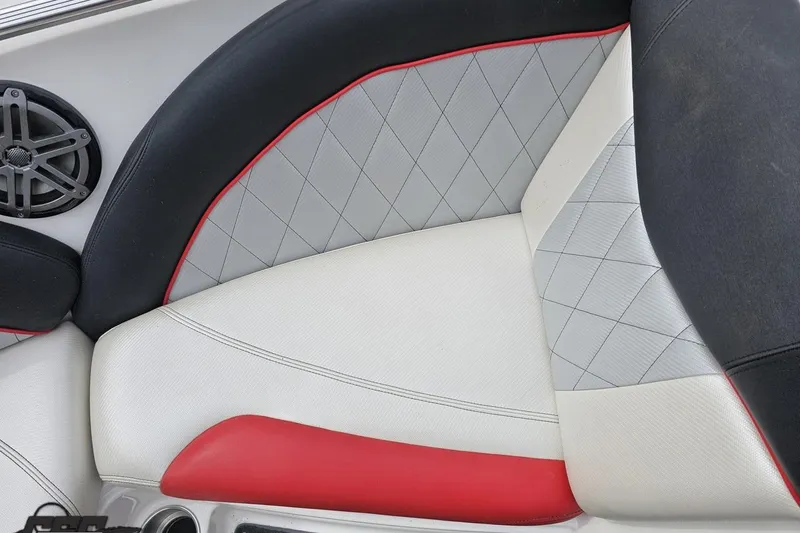 Slide: The Image of 2013 MasterCraft X-10 boat interior with diamond-stitched upholstery and speaker detail. - 77