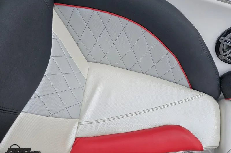 Slide: The Image of 2013 MasterCraft X-10 boat interior with diamond-stitched upholstery and red accents. - 79