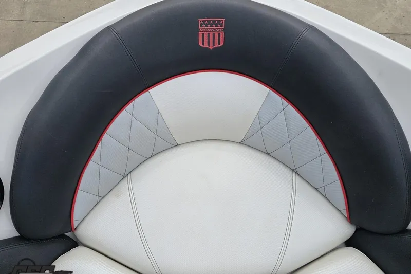 Slide: The Image of 2013 MasterCraft X-10 boat seat with black and white upholstery, red accents. - 82