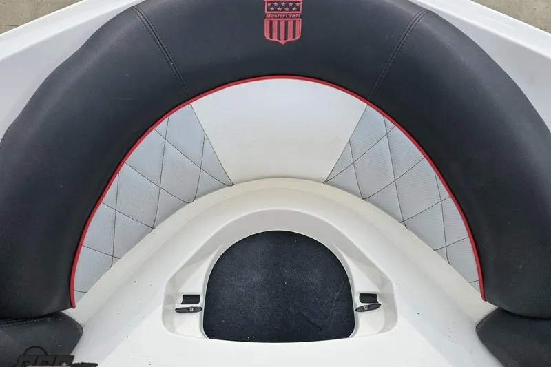 Slide: The Image of 2013 MasterCraft X-10 boat interior with black and white cushioned seating. - 83