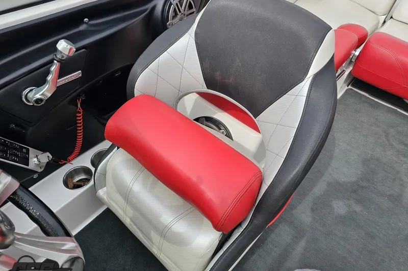 Slide: The Image of 2013 MasterCraft X-10 boat interior with red and white seating and control panel. - 89