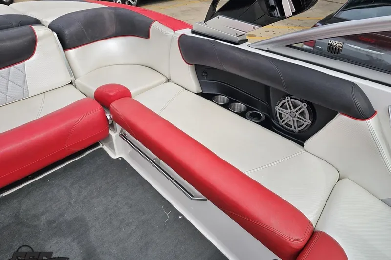 Slide: The Image of Interior of 2013 MasterCraft X-10 boat with red and white seating, cup holders, and speaker. - 91