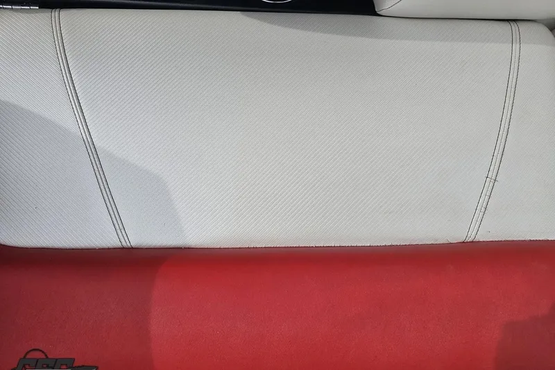 Slide: The Image of White and red upholstery in a 2013 MasterCraft X-10 boat interior. - 95