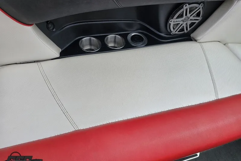 Slide: The Image of Interior of a 2013 MasterCraft X-10 boat with cup holders and speaker. - 97