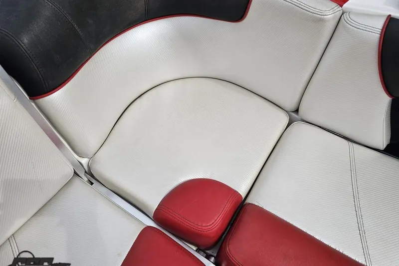 Slide: The Image of 2013 MasterCraft X-10 boat interior with white and red cushioned seating. - 99