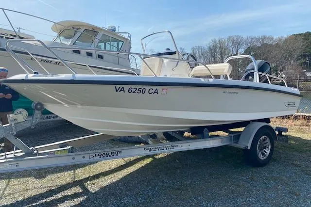 The Image of 2017 Boston Whaler 180 Dauntless boat on trailer, parked outdoors under blue sky. - 0