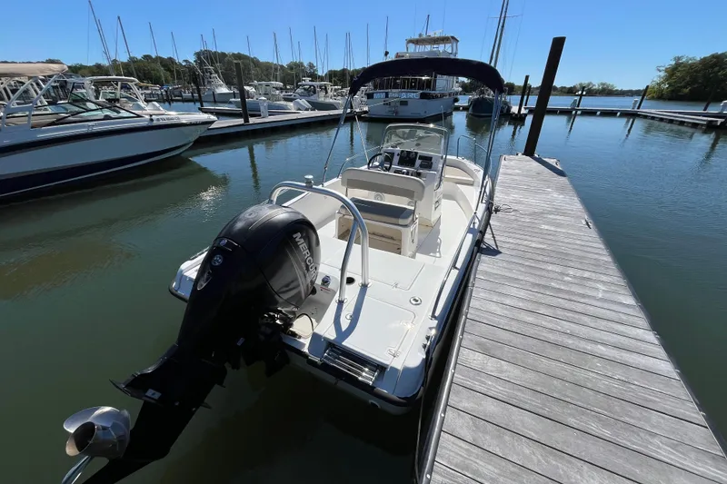 Slide: The Image of 2017 Boston Whaler 180 Dauntless boat docked at marina with Mercury outboard engine. - 11