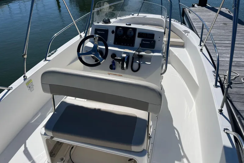 Slide: The Image of 2017 Boston Whaler 180 Dauntless boat interior with steering console and seating. - 7