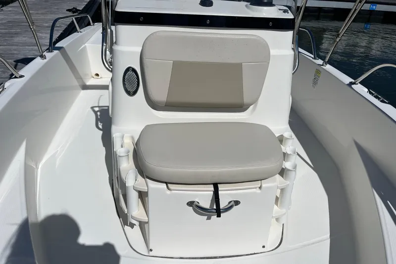 Slide: The Image of 2017 Boston Whaler 180 Dauntless boat interior with cushioned seating and rod holders. - 9