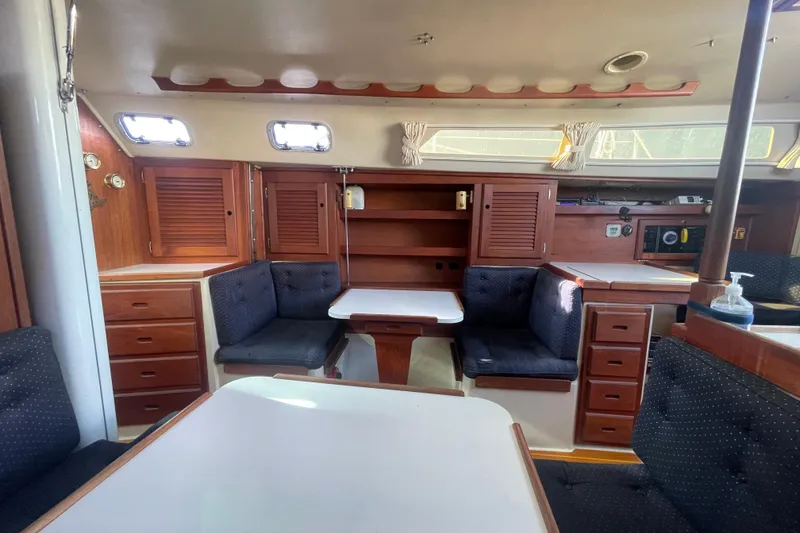 Slide: The Image of Interior of a 1989 Catalina 36 sailboat with wooden cabinetry and cushioned seating. - 13