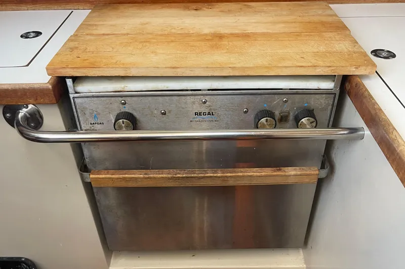Slide: The Image of Vintage 1989 Catalina 36 yacht kitchen with Regal gas oven and wooden countertop. - 14