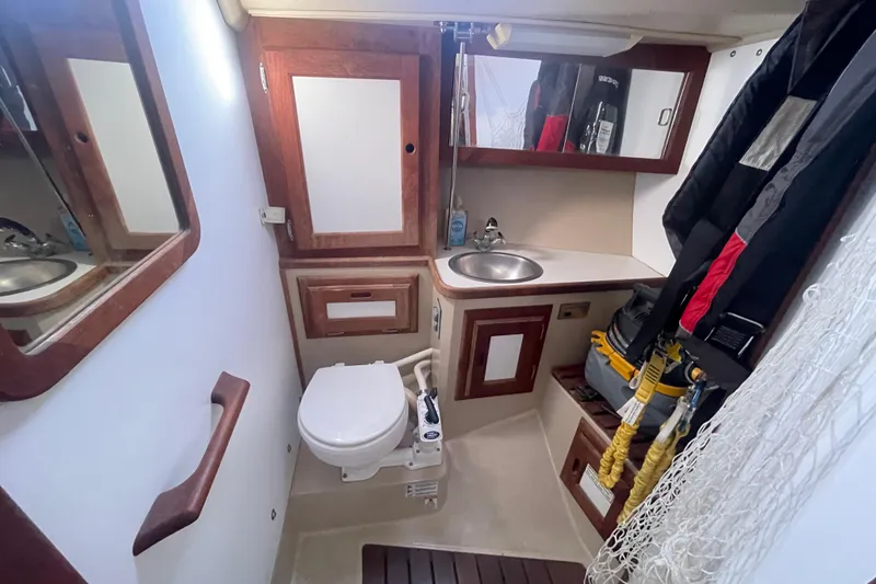 Slide: The Image of 1989 Catalina 36 yacht bathroom with sink, toilet, and storage cabinets. - 18