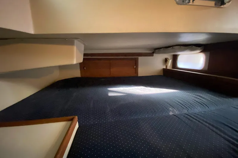 Slide: The Image of Interior cabin of a 1989 Catalina 36 sailboat with a cozy sleeping area. - 26