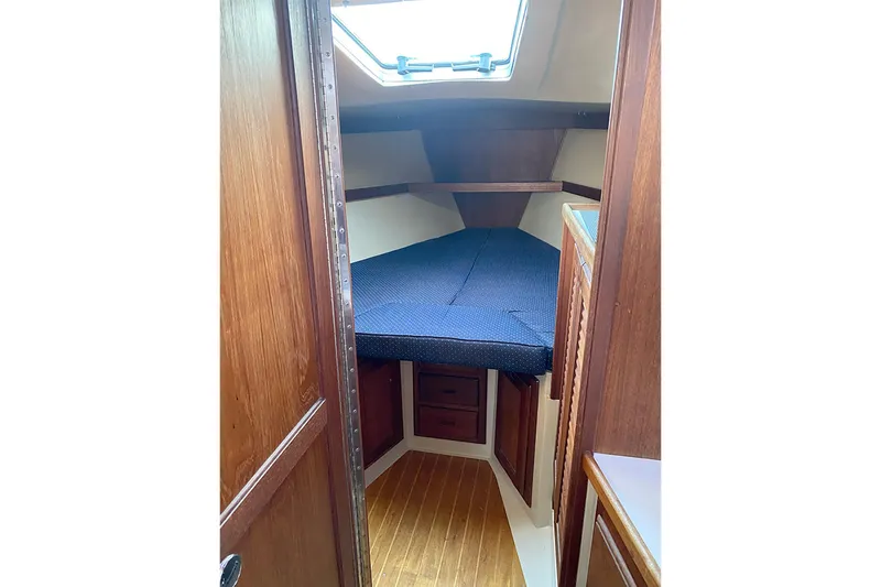 Slide: The Image of Cozy cabin interior of 1989 Catalina 36 sailboat with wooden finish and blue bedding. - 27