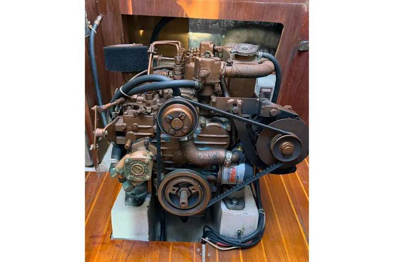 Slide: The Image of Engine of a 1989 Catalina 36 sailboat, showcasing mechanical components and belts. - 29