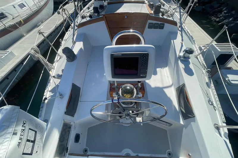 Slide: The Image of Cockpit of a 1989 Catalina 36 sailboat with navigation equipment and steering wheel. - 3