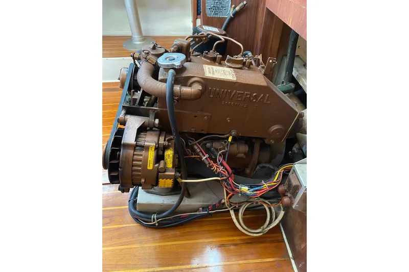 Slide: The Image of Engine of a 1989 Catalina 36 sailboat, featuring a Universal diesel motor. - 32