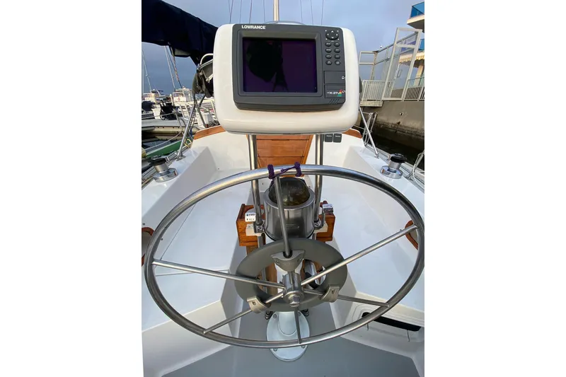 Slide: The Image of Cockpit of 1989 Catalina 36 sailboat with steering wheel and navigation system. - 34