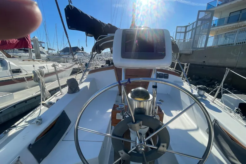 Slide: The Image of Cockpit view of a 1989 Catalina 36 sailboat with steering wheel and navigation equipment. - 4