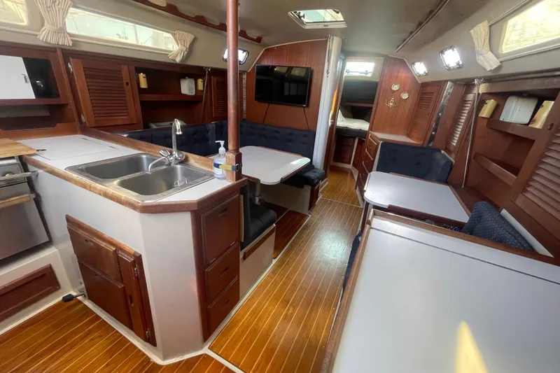 Slide: The Image of Interior of a 1989 Catalina 36 sailboat with wood finishes and cozy seating. - 8