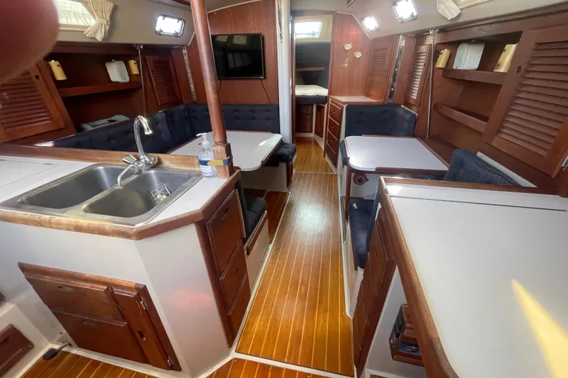 Slide: The Image of Interior of a 1989 Catalina 36 sailboat with wood finishes and cozy seating. - 9