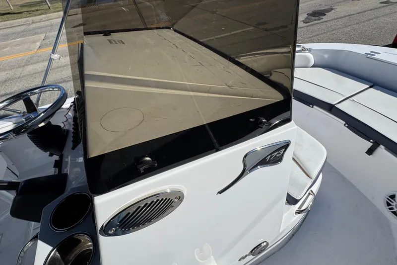 Slide: The Image of 2025 Stingray 173 CC boat console with steering wheel and seating area. - 10
