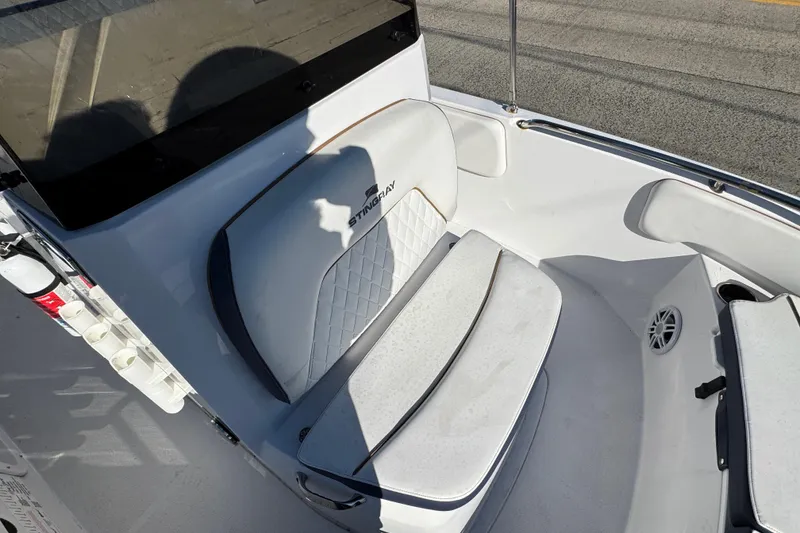 Slide: The Image of 2025 Stingray 173 CC boat interior with cushioned seating and rod holders. - 13