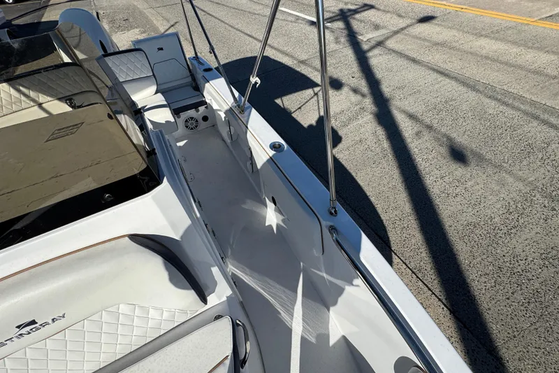 Slide: The Image of 2025 Stingray 173 CC boat interior with white seating and sleek design. - 15