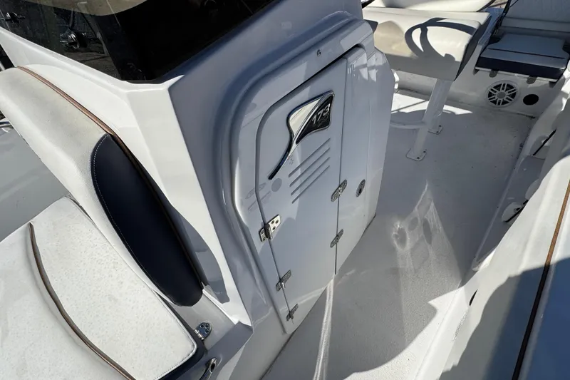 Slide: The Image of 2025 Stingray 173 CC boat interior, featuring sleek seating and storage compartments. - 17