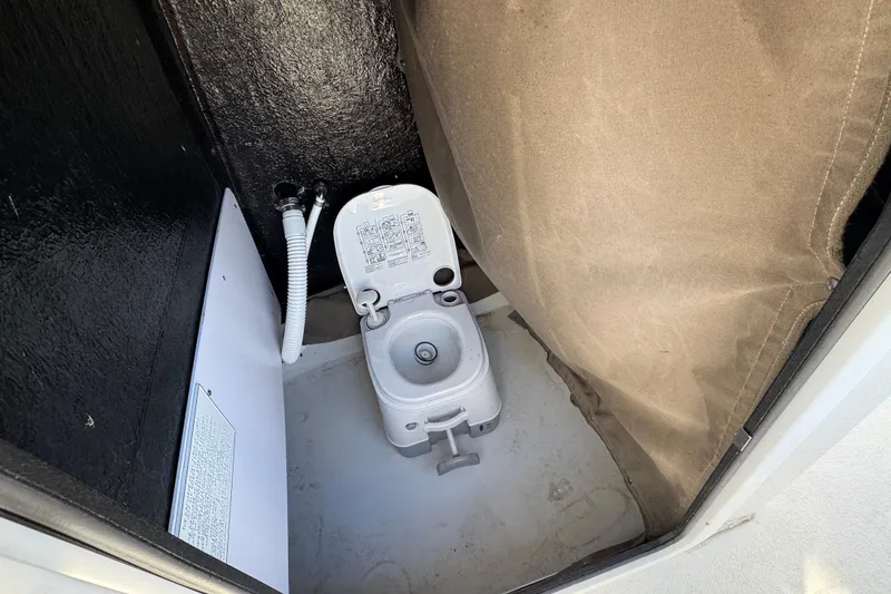 Slide: The Image of Compact marine toilet in 2025 Stingray 173 CC boat cabin. - 18