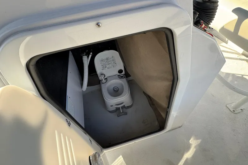 Slide: The Image of Portable toilet inside 2025 Stingray 173 CC boat compartment. - 19