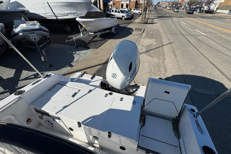 Slide: The Image of 2025 Stingray 173 CC boat with Suzuki outboard motor, parked on urban street. - 20