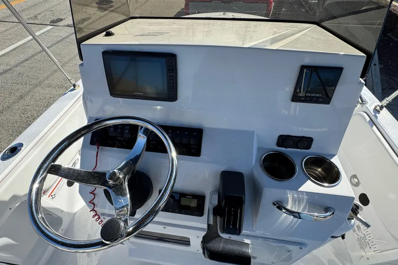 Slide: The Image of 2025 Stingray 173 CC boat dashboard with steering wheel, Garmin display, and Suzuki controls. - 4