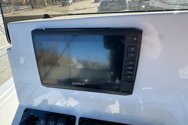 Slide: The Image of Garmin display on 2025 Stingray 173 CC boat dashboard, showing control buttons. - 5