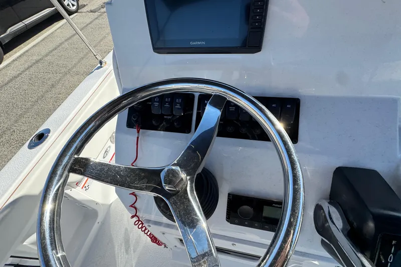 Slide: The Image of 2025 Stingray 173 CC boat dashboard with steering wheel and Garmin display. - 8