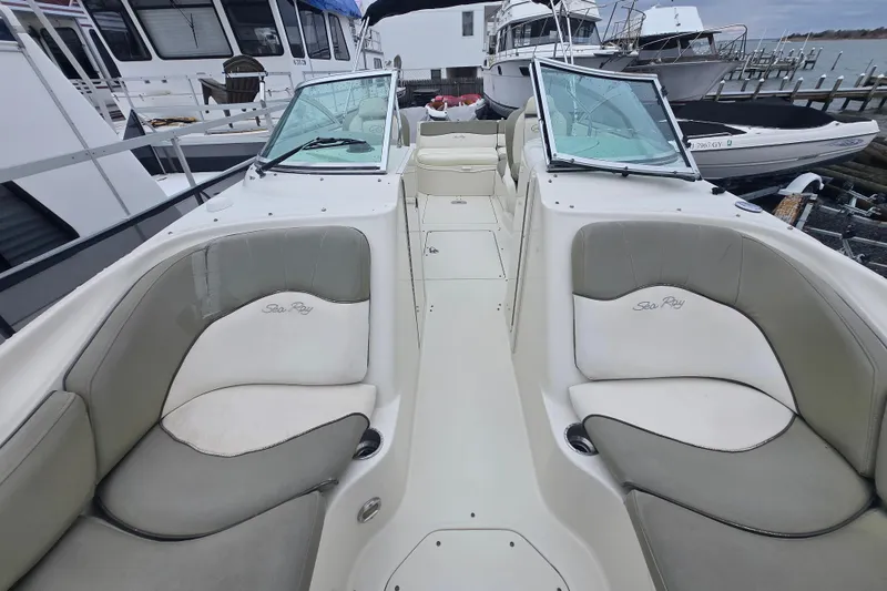 Slide: The Image of 2007 Sea Ray 240 Sundeck boat interior with seating, docked at a marina. - 12