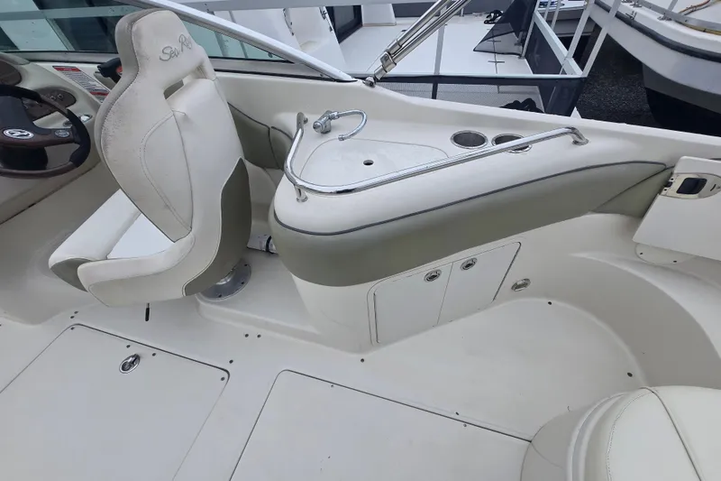 Slide: The Image of 2007 Sea Ray 240 Sundeck interior with helm seat and console details. - 14