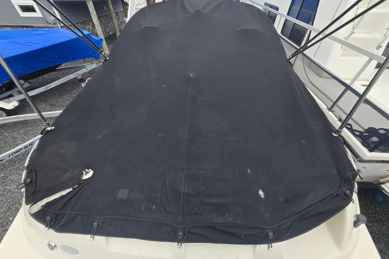 Slide: The Image of Covered 2007 Sea Ray 240 Sundeck boat, black tarp, docked outdoors. - 19