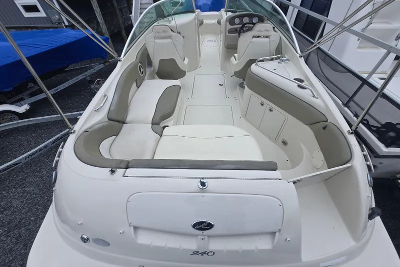 Slide: The Image of 2007 Sea Ray 240 Sundeck boat interior with seating and dashboard view. - 2