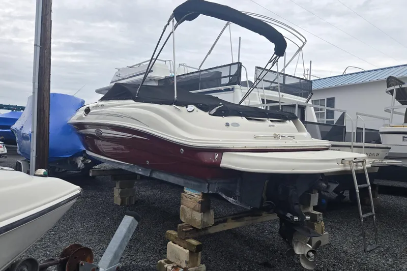 Slide: The Image of 2007 Sea Ray 240 Sundeck boat on blocks, covered and stored outdoors. - 20