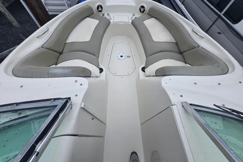 Slide: The Image of 2007 Sea Ray 240 Sundeck interior with beige seating and spacious layout. - 8