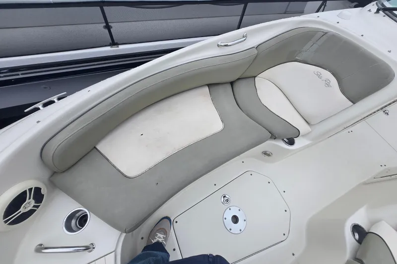 Slide: The Image of 2007 Sea Ray 240 Sundeck boat interior with cushioned seating and speaker. - 9